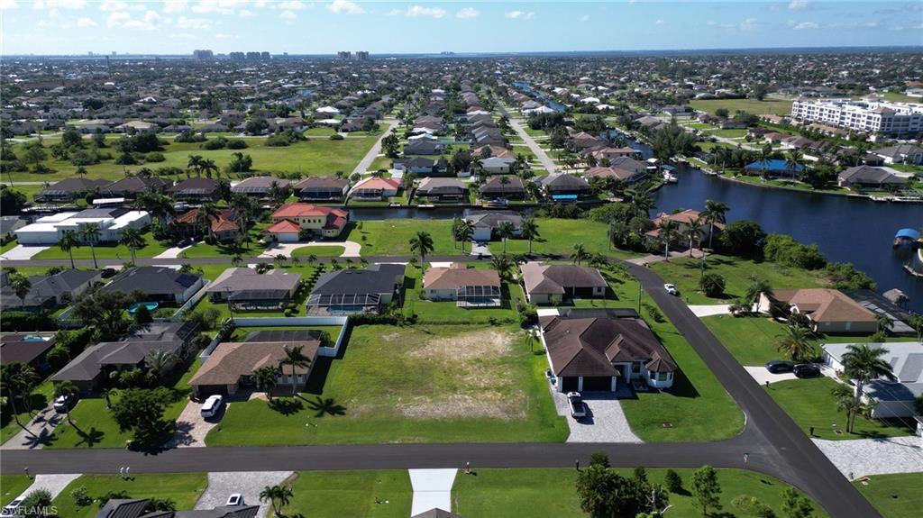 Image 1: Aerial view of property and surrounding area featuring a nearby body of water