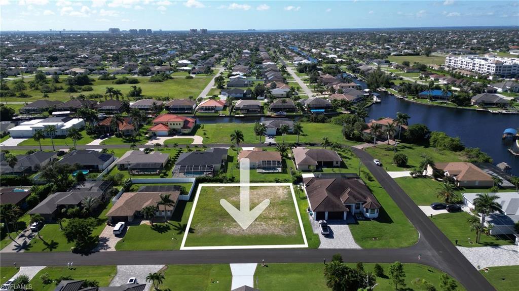 Image 3: Aerial overview of property's location featuring a large body of water and property boundaries highlighted