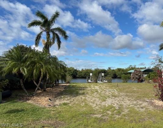 Image 1: View of green lawn featuring a water view
