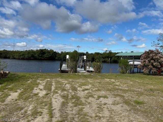 Image 4: Dock area featuring boat lift and a water view