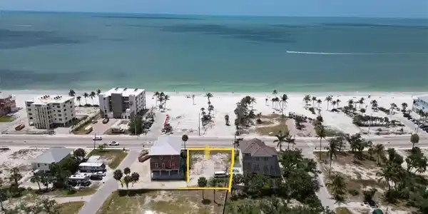 Image 4: Aerial view of property's location with property parcel outlined and extended coastline