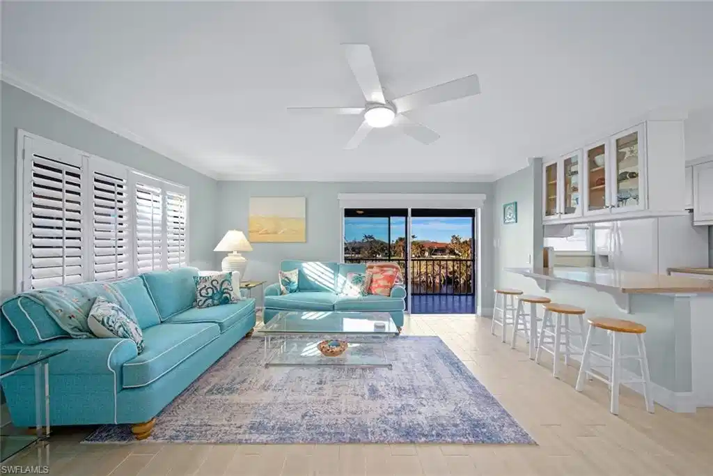 Image 1: Living area with light wood-type flooring, ornamental molding, and a ceiling fan