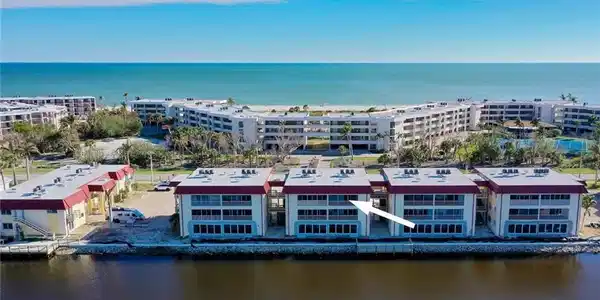 Image 2: Aerial view of apartment complex / building and a large body of water