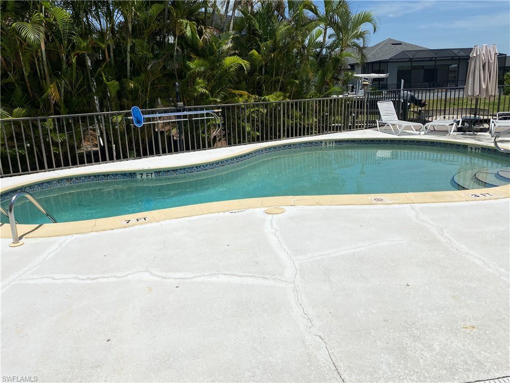 Image 2: Community pool featuring a patio area