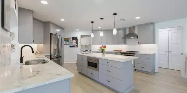 Image 4: Kitchen featuring gray cabinetry, pendant lighting, wall chimney exhaust hood, stainless steel appliances, and recessed lighting