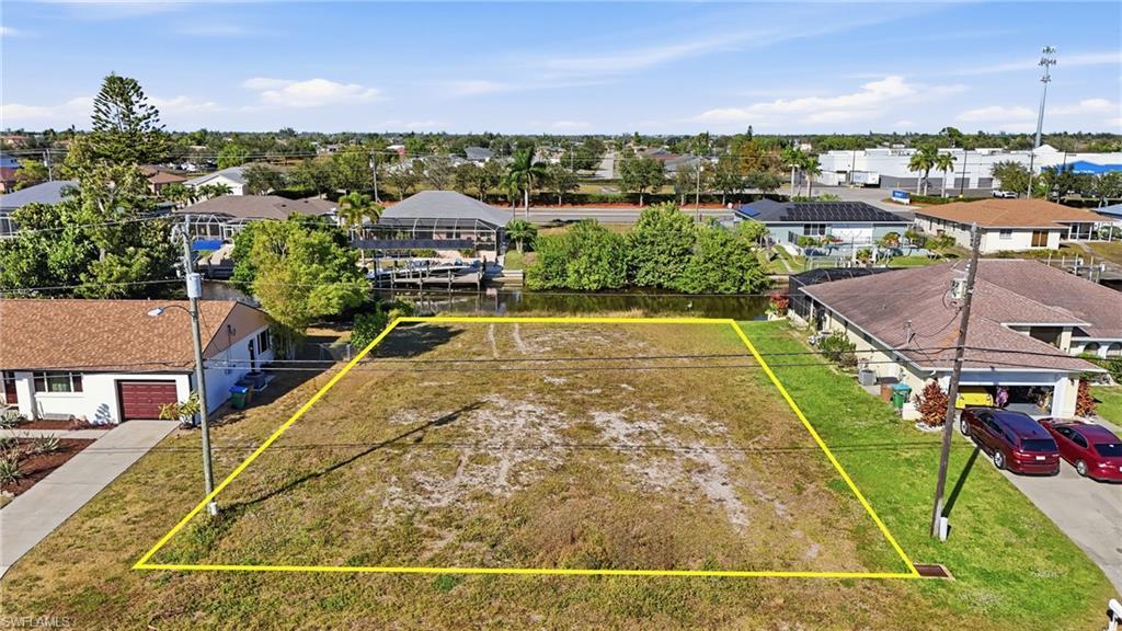 Image 3: Aerial perspective of suburban area featuring property parcel outlined