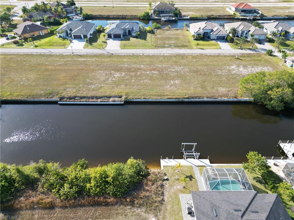 Image 2: Aerial perspective of suburban area with a nearby body of water
