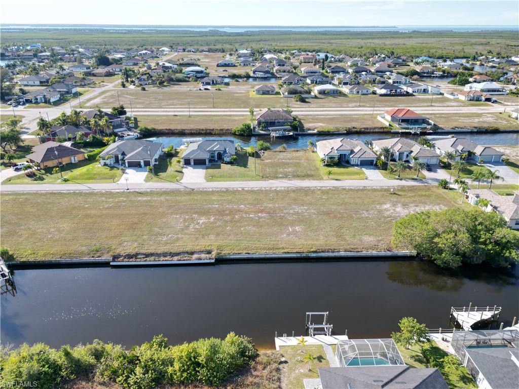 Image 4: Aerial view of residential area featuring a large body of water