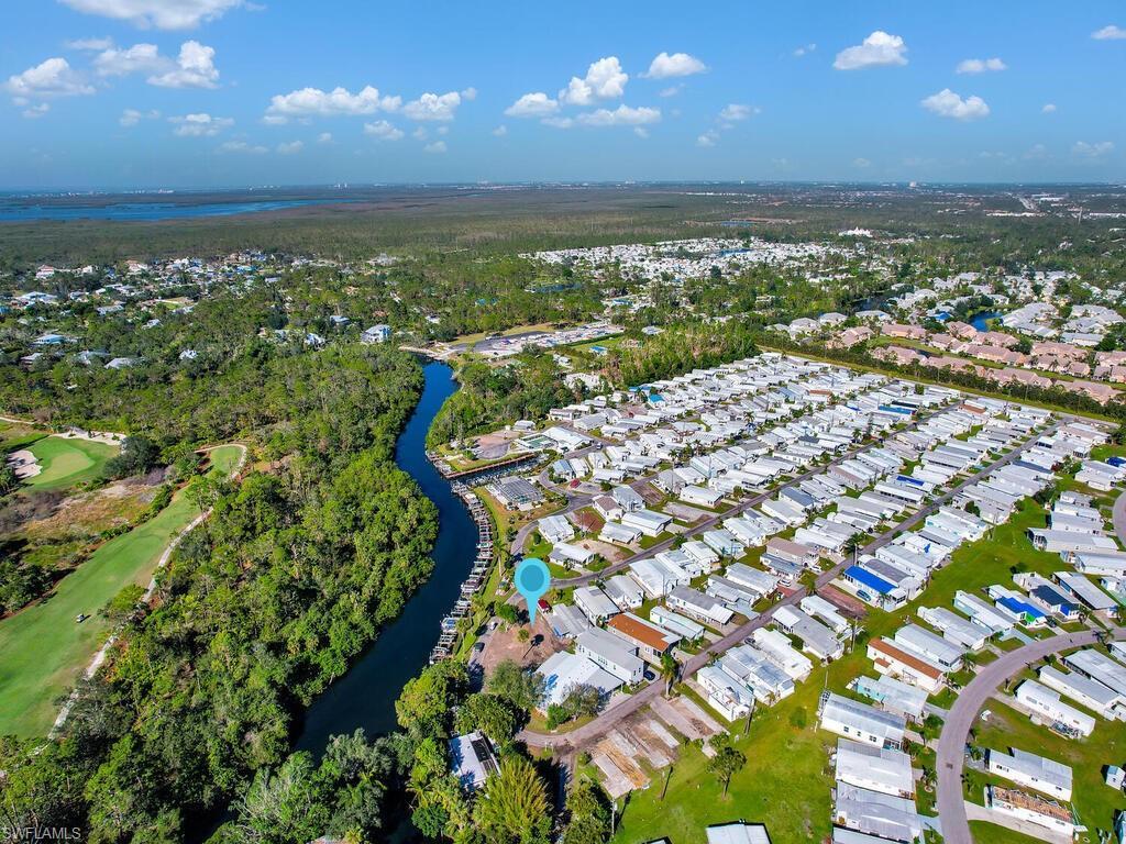 Image 2: View of property location featuring a large body of water and nearby suburban area