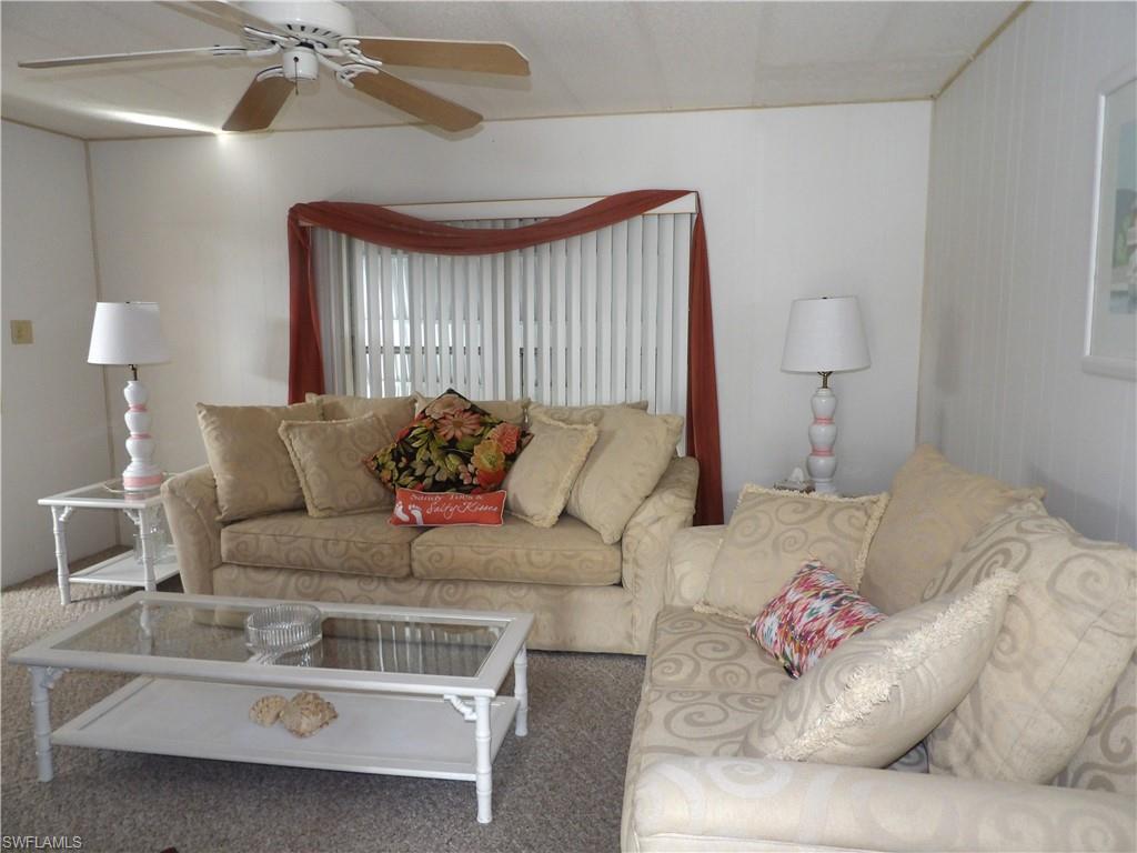 Image 4: Living area featuring carpet and ceiling fan