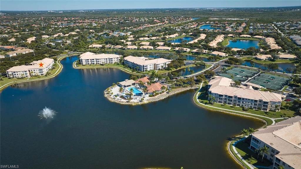Image 2: Aerial view of apartment complex and a large body of water