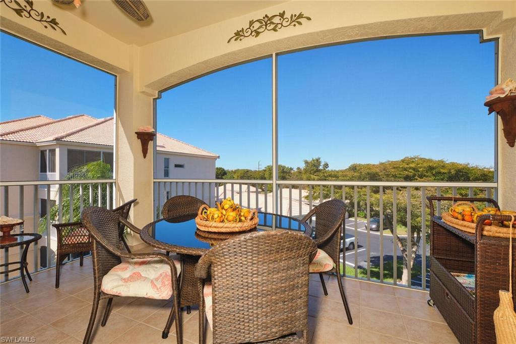 Image 3: Balcony featuring a sunroom and outdoor dining area