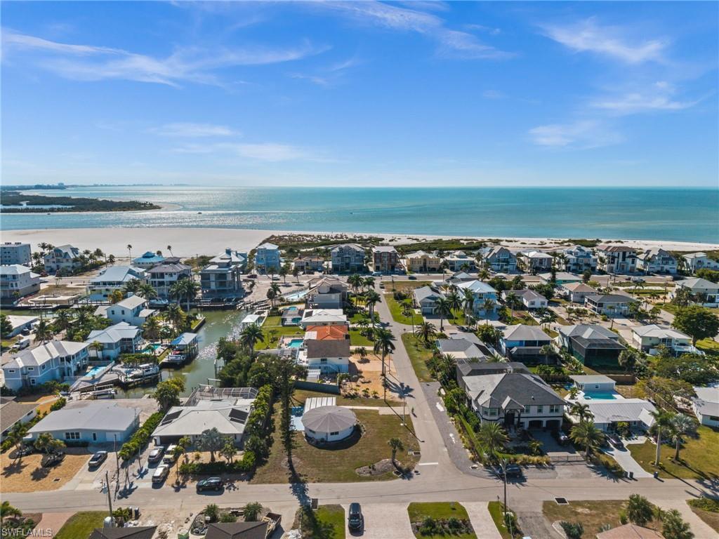 Image 1: Aerial view of residential area with a nearby body of water