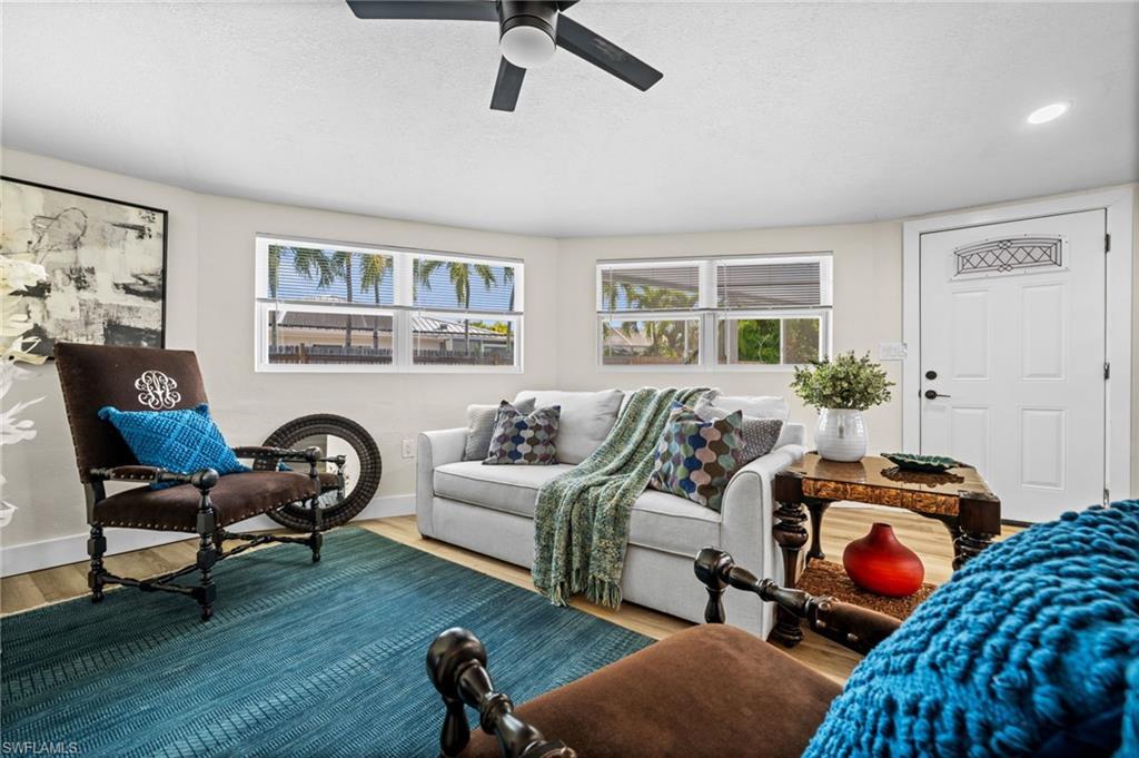 Image 4: Living room featuring wood finished floors, healthy amount of natural light, and ceiling fan
