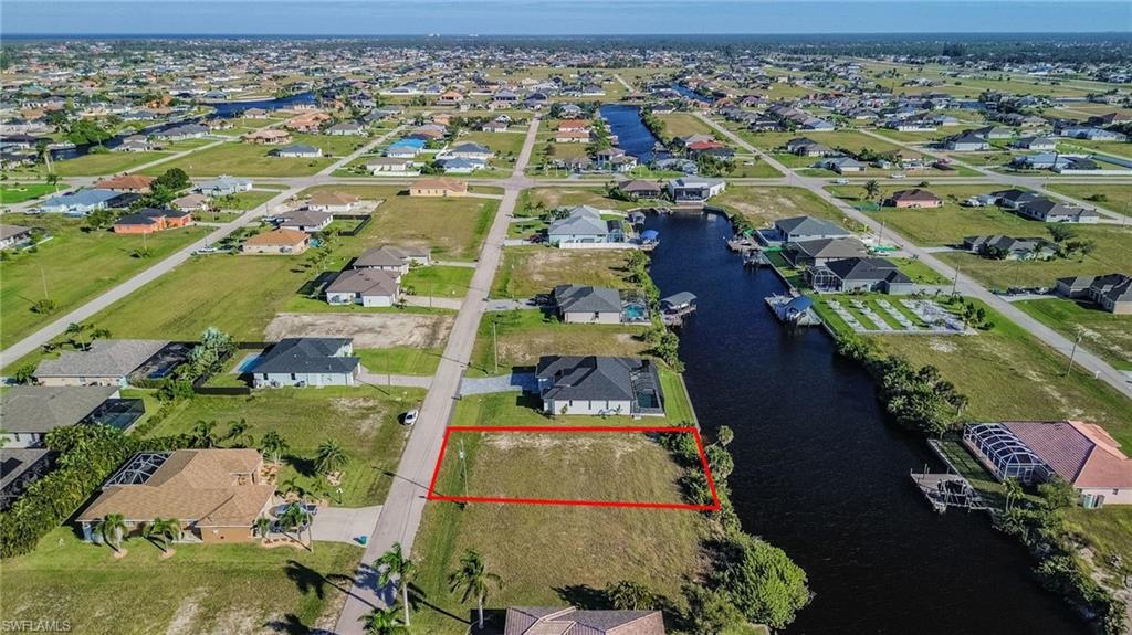 Image 3: Aerial perspective of suburban area with property boundaries highlighted and a nearby body of water
