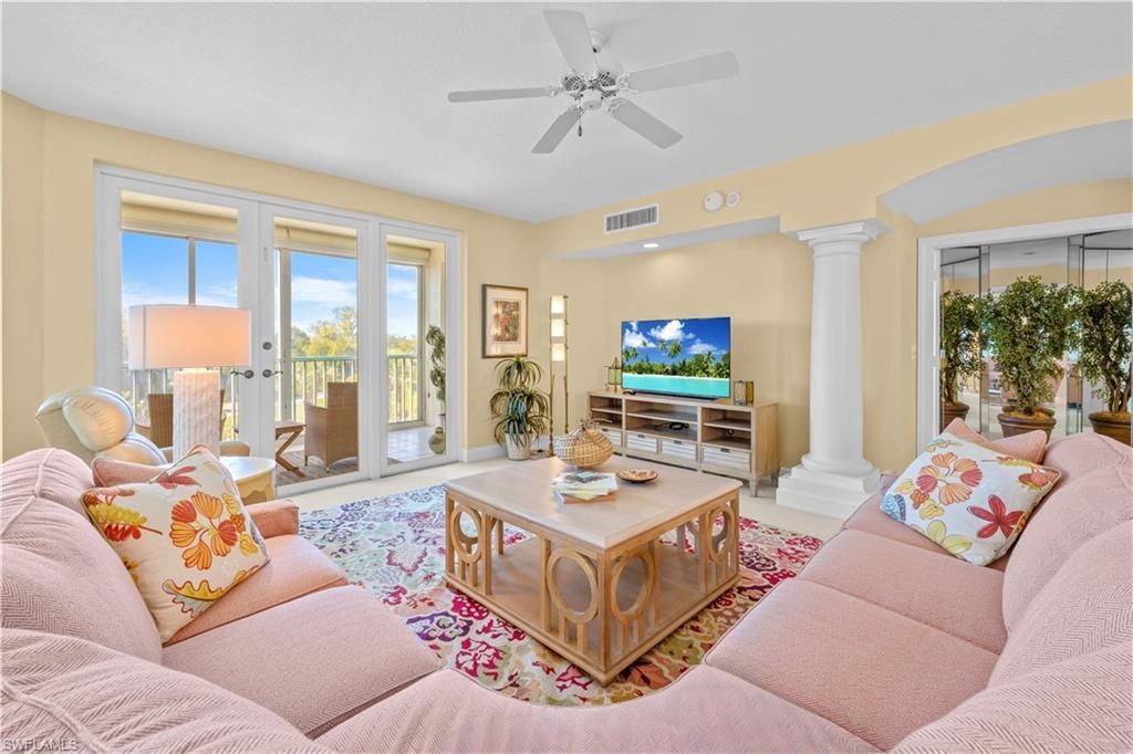 Image 3: Living area with ornate columns and a ceiling fan