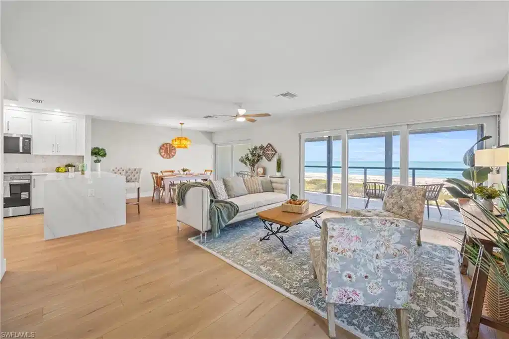 Image 1: Living area with a water view, light wood-type flooring, and a ceiling fan