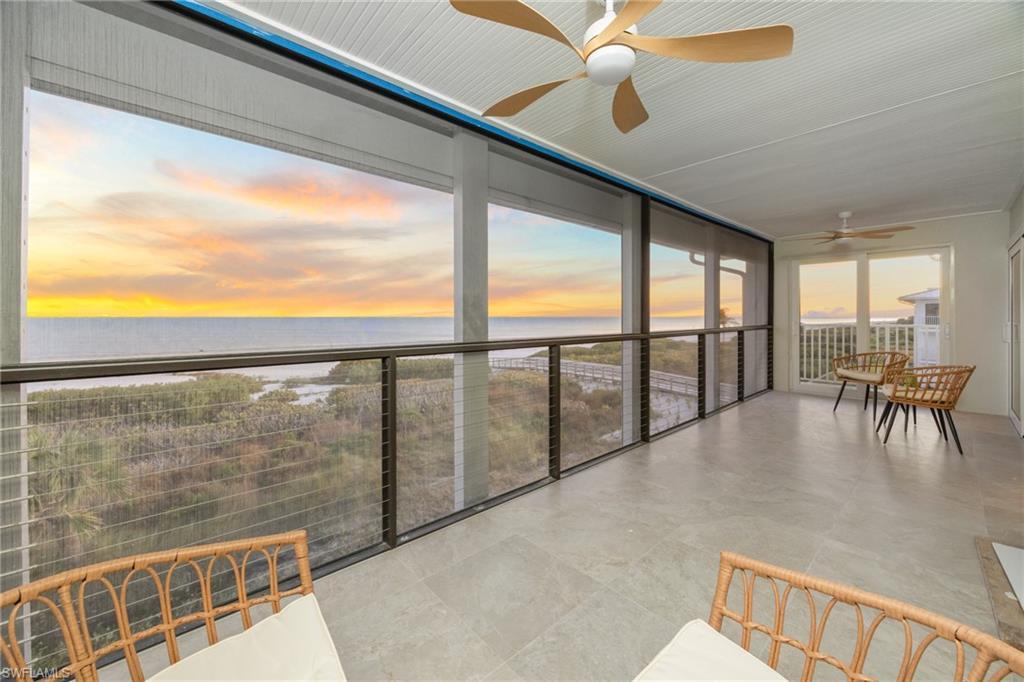 Image 2: Sunroom featuring a ceiling fan and a water view