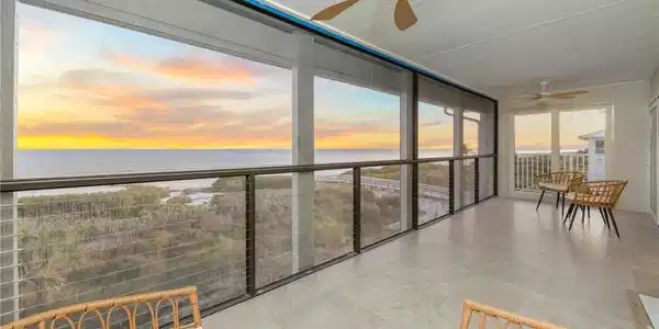 Image 2: Sunroom featuring a ceiling fan and a water view