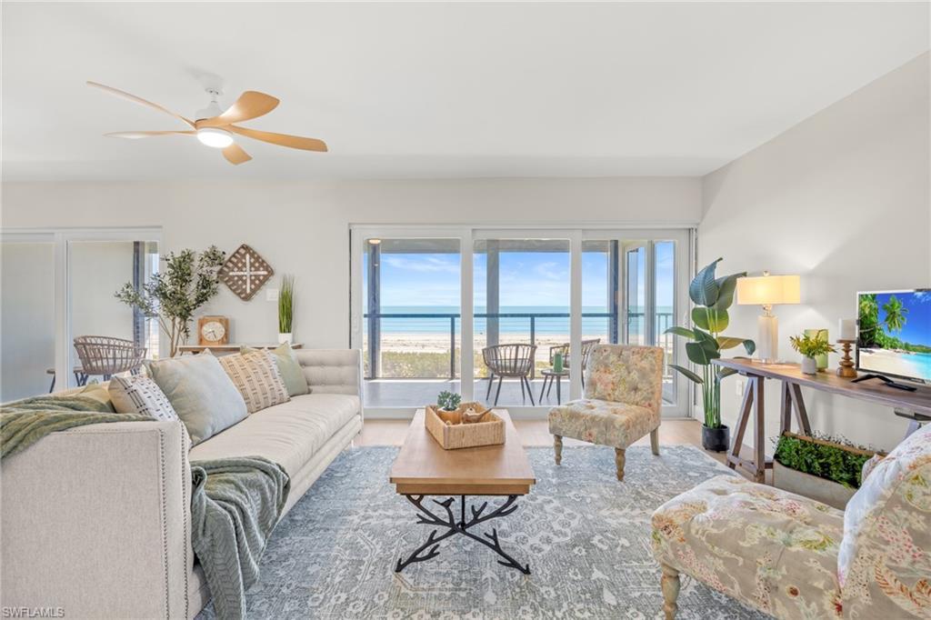 Image 3: Living area featuring ceiling fan and wood finished floors