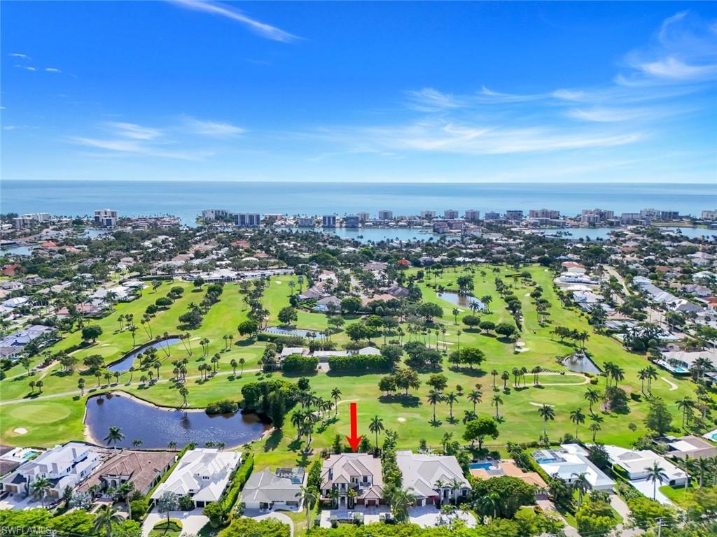 Image 2: Aerial overview of property's location with a large body of water and nearby suburban area