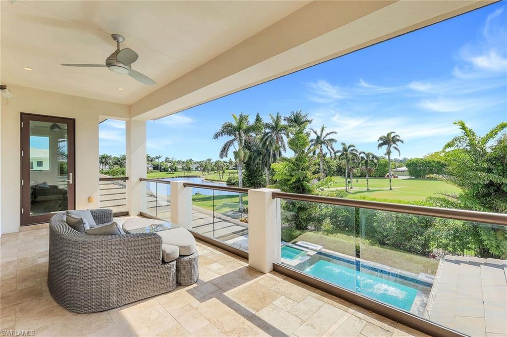 Image 3: 2nd Floor Balcony with a water view, view of golf course, ceiling fan, view of pool area, and a pool with connected hot tub