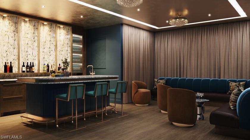 Image 3: Community bar area with wood finished floors and recessed lighting