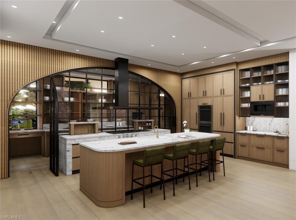 Image 4: Kitchen with open shelves, light wood-type flooring, a spacious island, a breakfast bar, and light stone counters