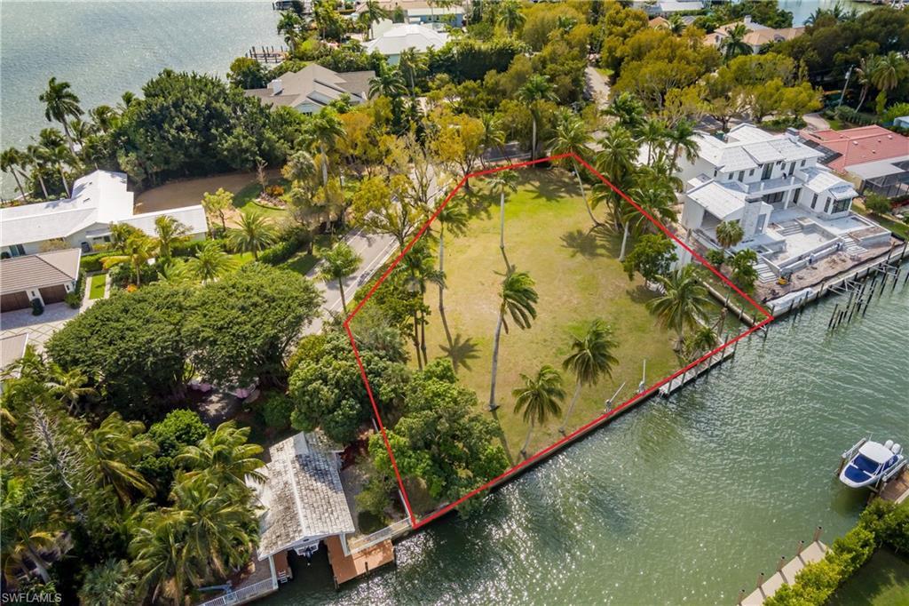 Image 3: Aerial view of property and surrounding area featuring a large body of water and property parcel outlined