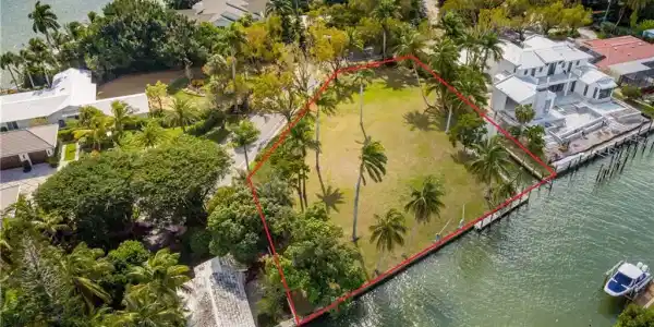 Image 3: Aerial view of property and surrounding area featuring a large body of water and property parcel outlined