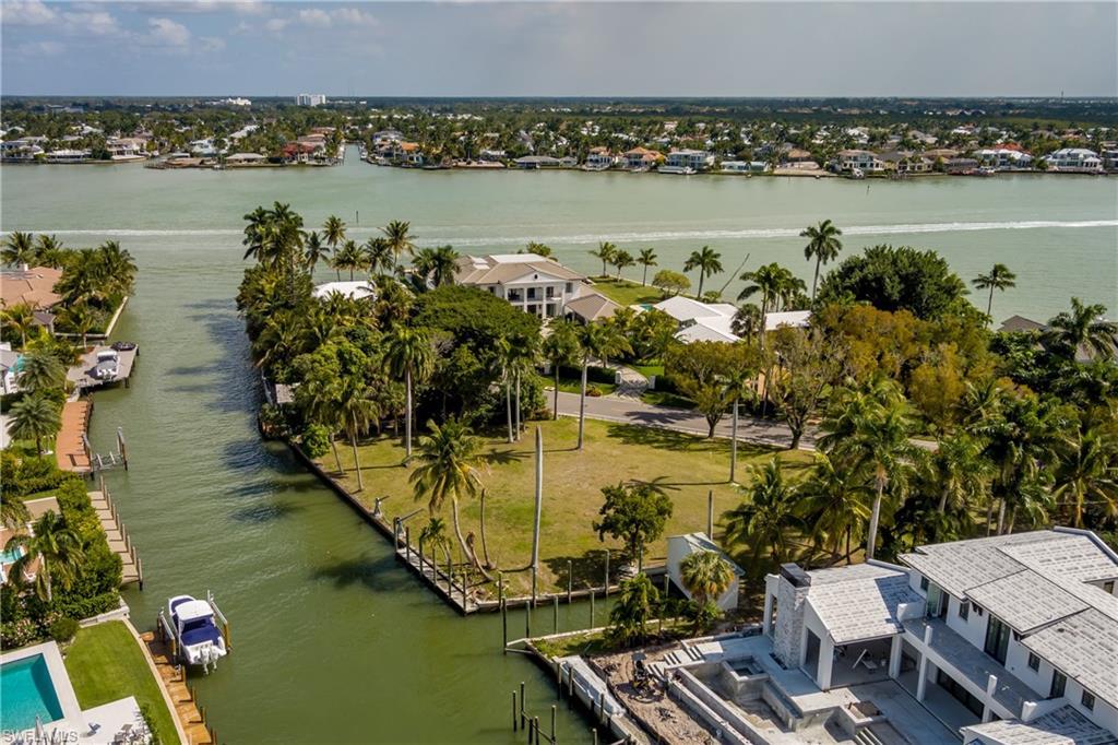 Image 4: Aerial perspective of suburban area featuring a nearby body of water