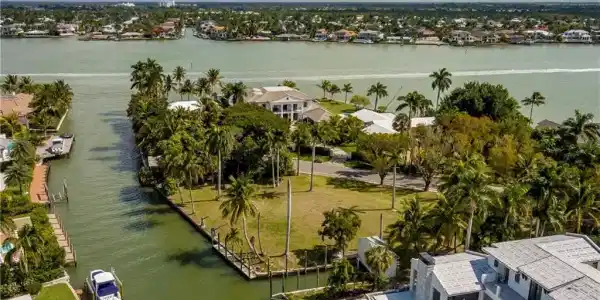 Image 4: Aerial perspective of suburban area featuring a nearby body of water