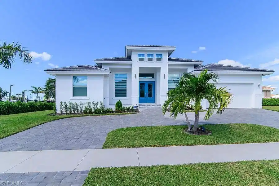 Image 1: Single story house featuring french doors, a front yard, decorative driveway, an attached garage, and stucco siding