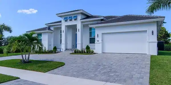 Image 2: Single story home featuring decorative driveway, a front lawn, stucco siding, and an attached garage