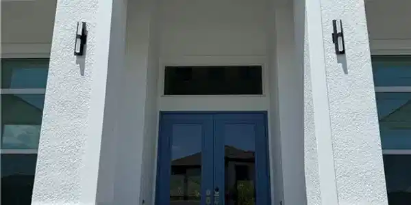 Image 4: Property entrance featuring french doors and stucco siding