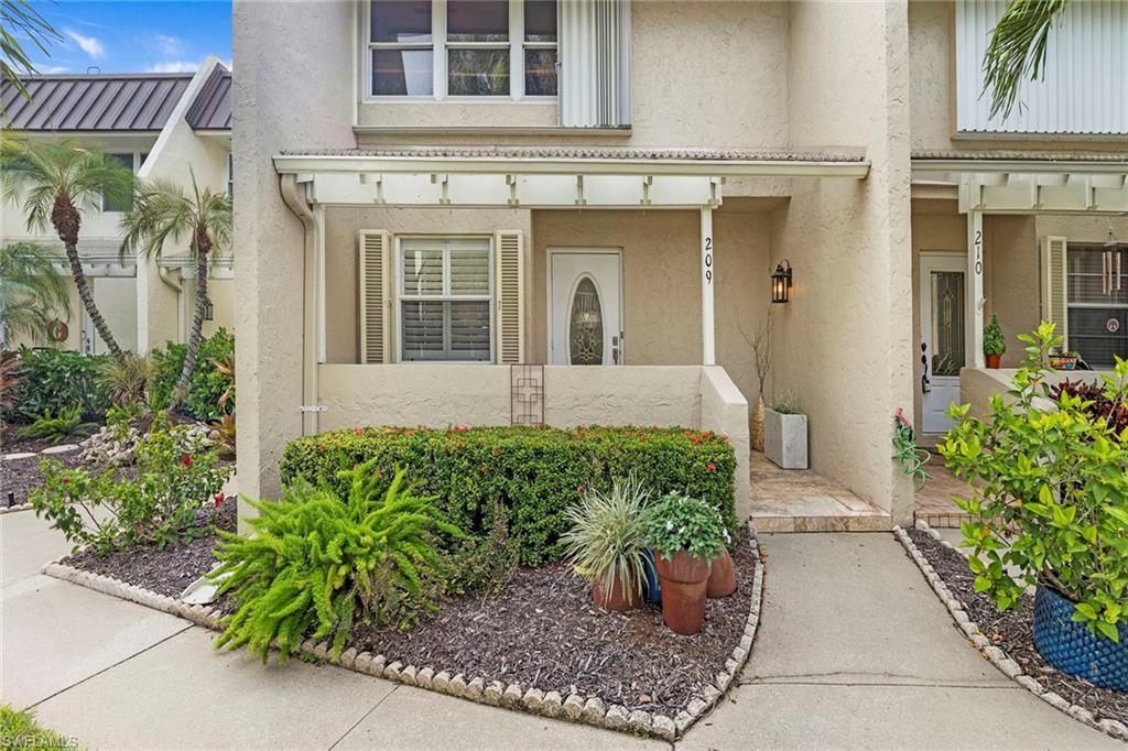 Image 3: Property entrance with stucco siding and a porch