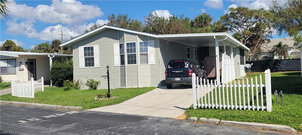 Image 4: View of front of property featuring a carport and a front yard