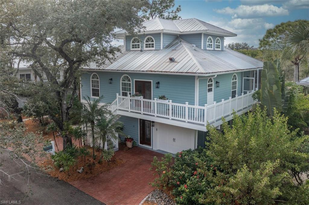 Image 1: Key West Style Home featuring a metal roof