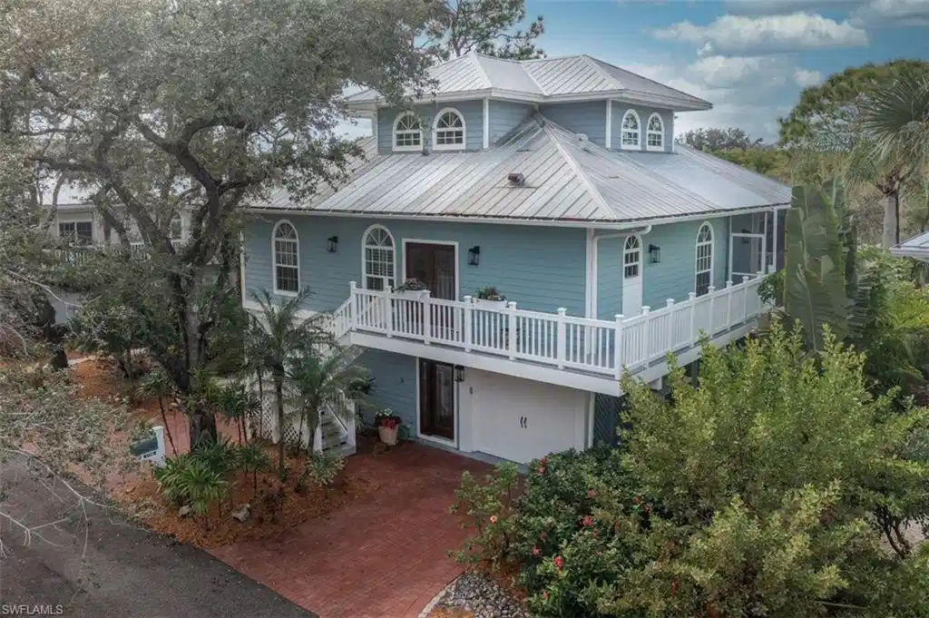 Image 1: Key West Style Home featuring a metal roof