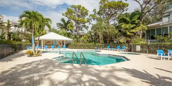 Image 4: Cracker Cove Community pool with a patio