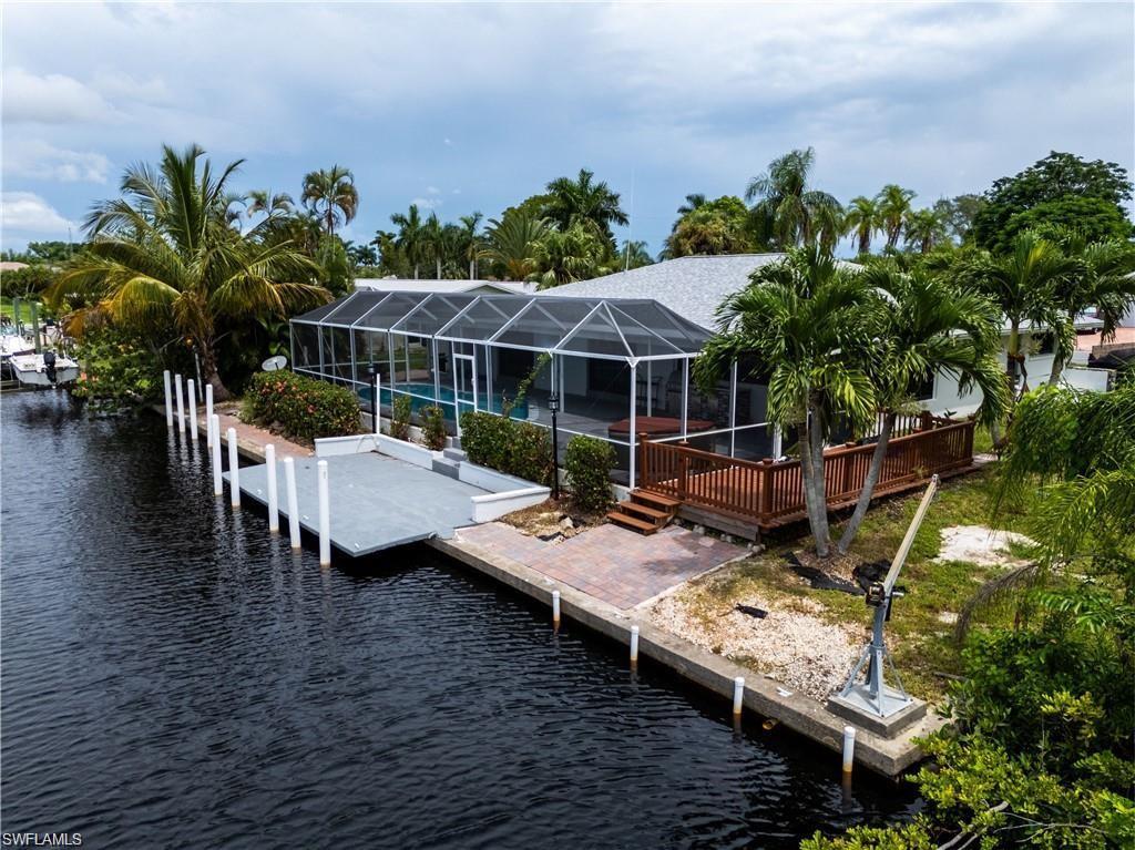 Image 3: Dock area with glass enclosure, a sunroom, a swimming pool, and a deck with water view