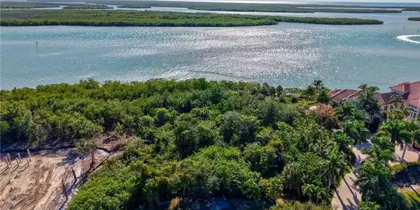 Image 2: Aerial view of property and surrounding area featuring a large body of water