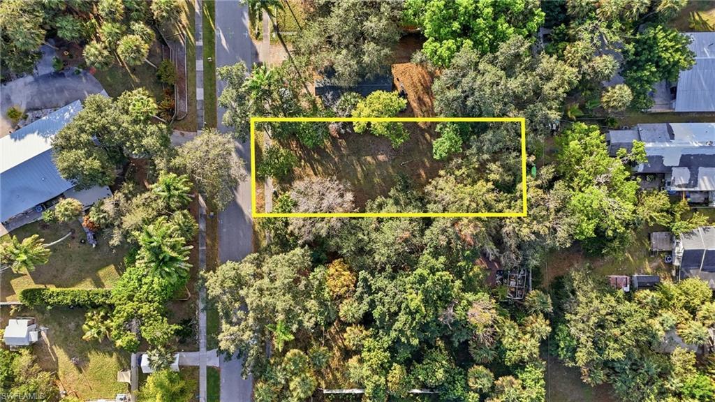 Image 4: Aerial view of property's location featuring property parcel outlined and a nearby body of water