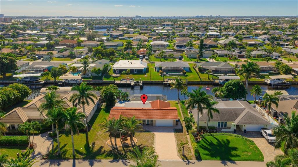 Image 2: View of property location featuring a nearby body of water and nearby suburban area