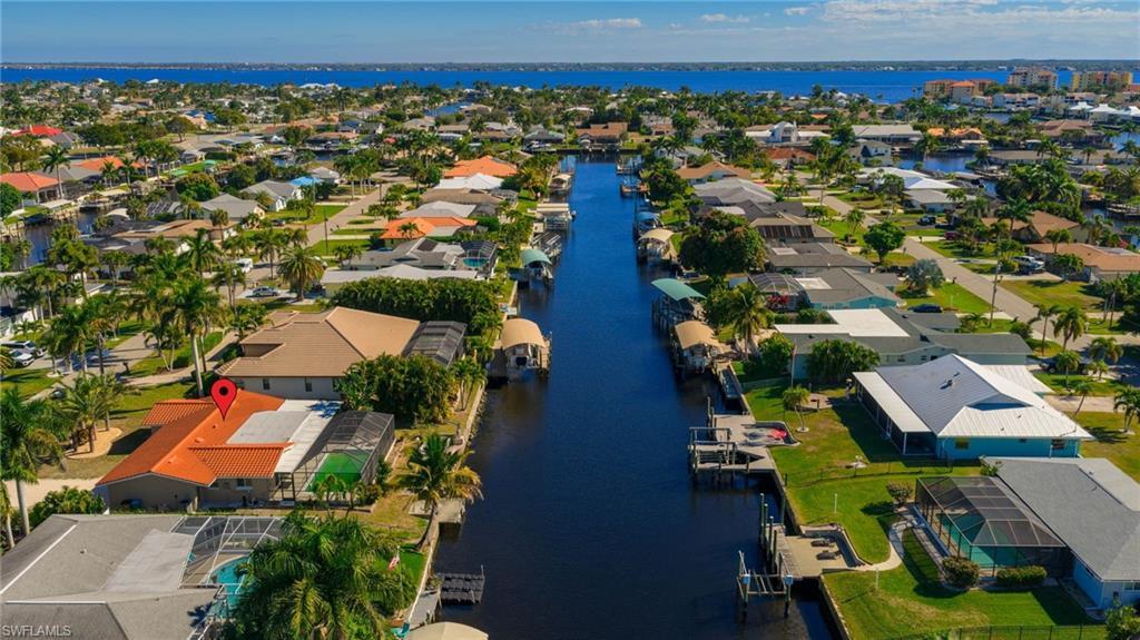 Image 3: Aerial view of property's location with a nearby body of water and nearby suburban area