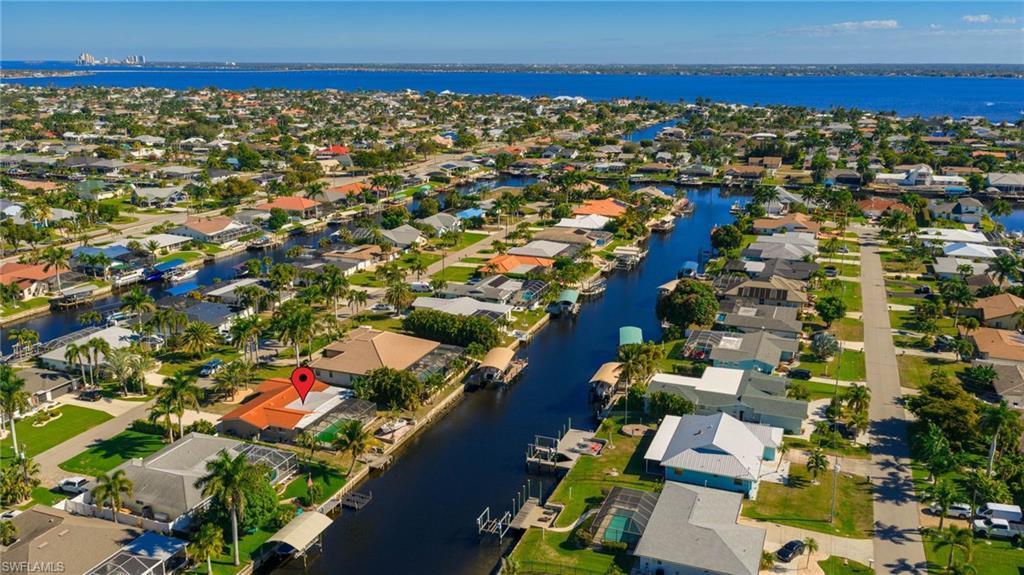 Image 4: Aerial overview of property's location featuring a large body of water and nearby suburban area