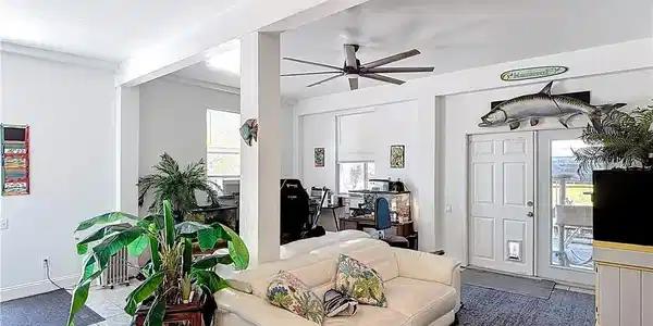 Image 4: Living area featuring a ceiling fan and tile patterned flooring