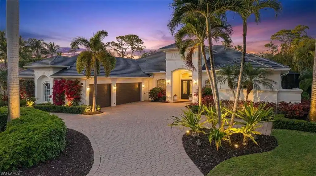 Image 1: View of front of house featuring a tile roof, decorative driveway, an attached garage, and stucco siding