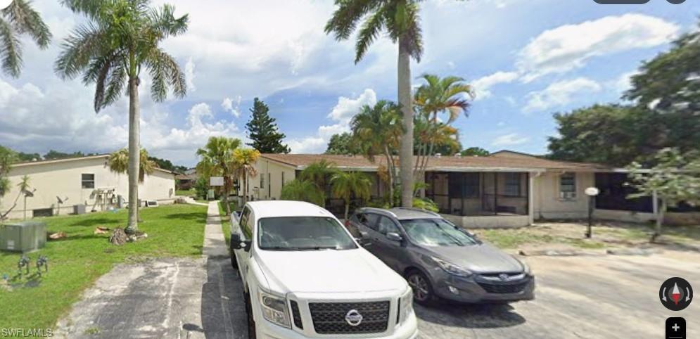 Image 1: View of front of property with a front yard, a residential view, and uncovered parking
