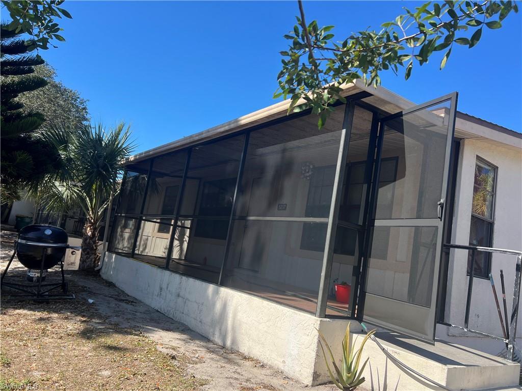 Image 4: View of side of home featuring a sunroom